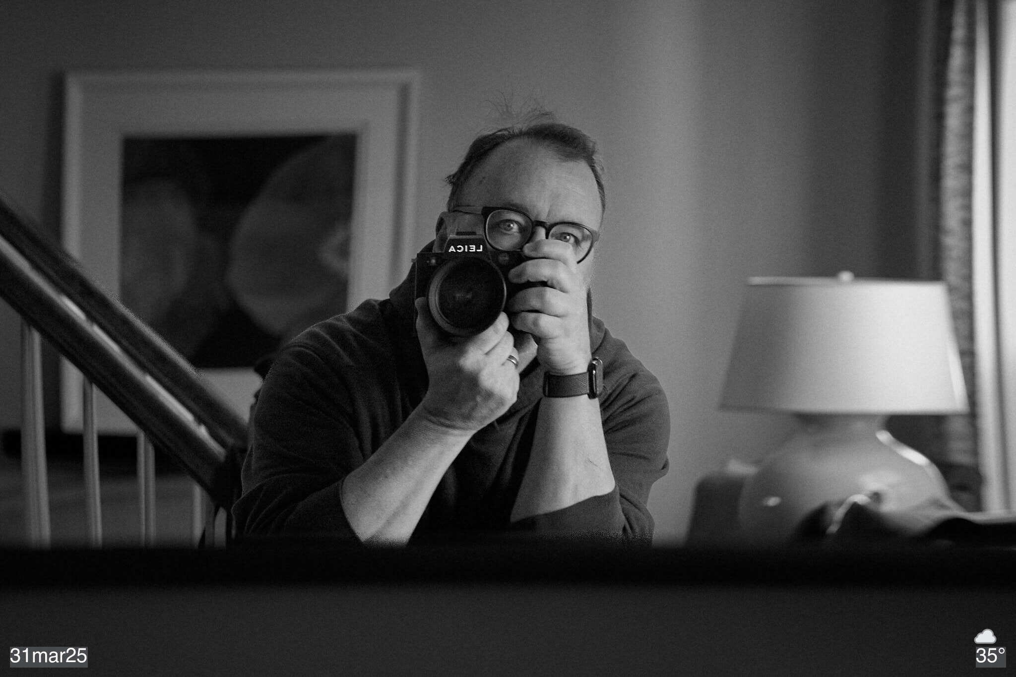Black and white self-portrait in mirror